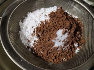 Sift Icing Sugar And Cocoa Powder Over The Creamed Mixture