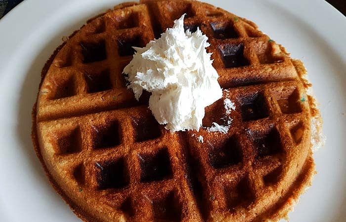 Dollop of frosting on waffle.