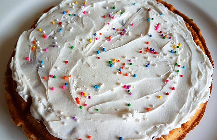 Top frosted waffle with sprinkles.