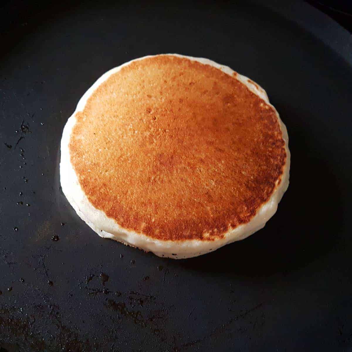 Cook until bubbles appear on the face of the pancake. Carefully flip the pancake and cook until its golden brown.